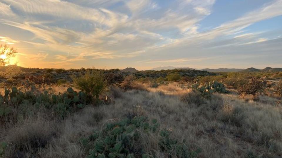 <div>The wispy clouds dance over the desert hills in Palo Verde! Thanks to Dion Romero for sending us this photo!</div>