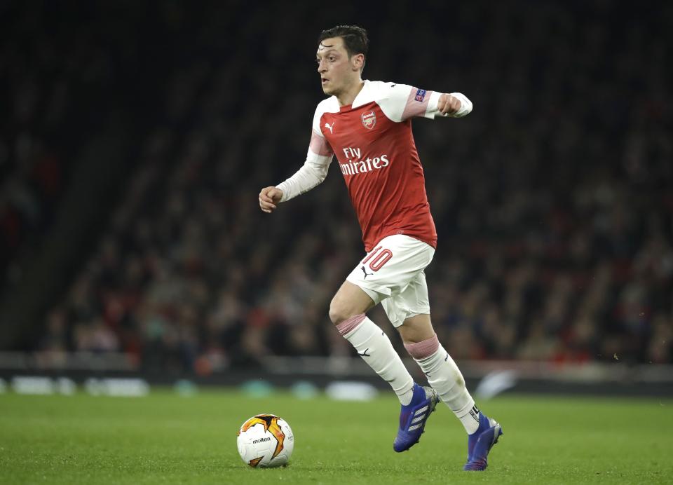 Arsenal's Mesut Ozil controls the ball during the Europa League round of 32 second leg soccer match between Arsenal and Bate at the Emirates stadium in London, Thursday, Feb. 21, 2019. (AP Photo/Matt Dunham)