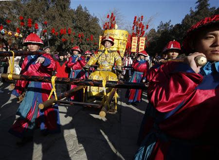 A performer dressed as a Qing dynasty emperor rides a palanquin during the opening of the temple fair for Chinese New Year celebrations at Ditan Park, also known as the Temple of Earth, in Beijing January 30, 2014. REUTERS/Kim Kyung-Hoon