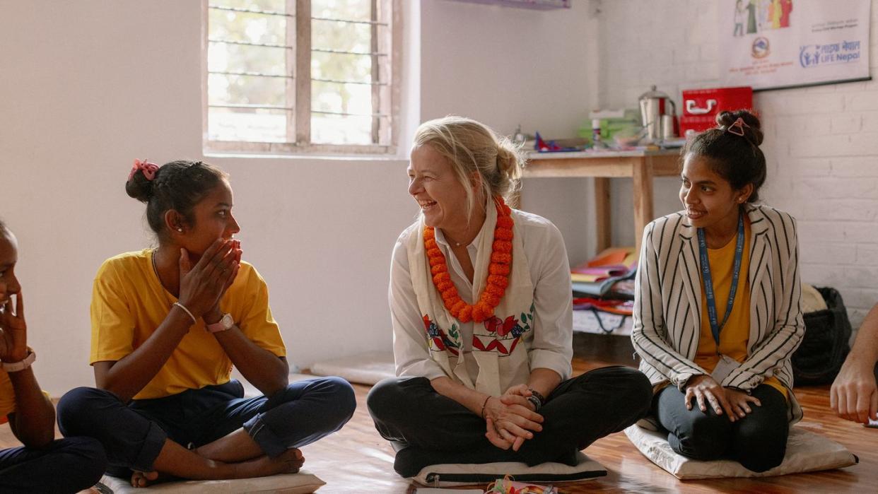 a group of women sitting on the floor