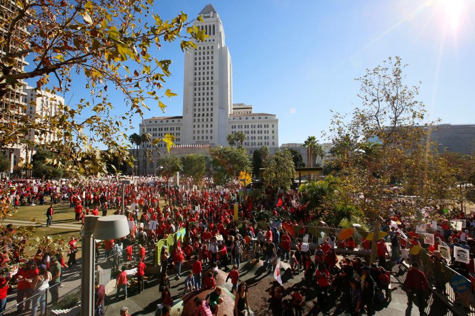 In this Saturday, Dec. 15, 2018, photo, thousands of teachers marched and rallied outside Los Angeles City Hall. Teachers in the nation's second-largest school district will go on strike next month if there's no settlement of its long-running contract dispute, union leaders said Wednesday, Dec. 19. The announcement by United Teachers Los Angeles threatens the first strike against the Los Angeles Unified School District in nearly 30 years and follows about 20 months of negotiations. (AP Photo/Damian Dovarganes) ORG XMIT: CADD306