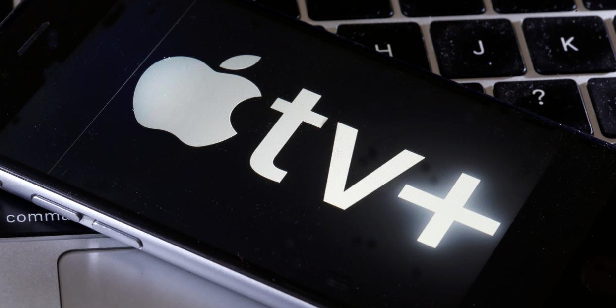 Apple TV Plus logo on an iPhone on a Macbook