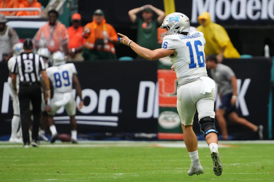 Middle Tennessee quarterback Chase Cunningham celebrates after throwing a touchdown pass against Miami.