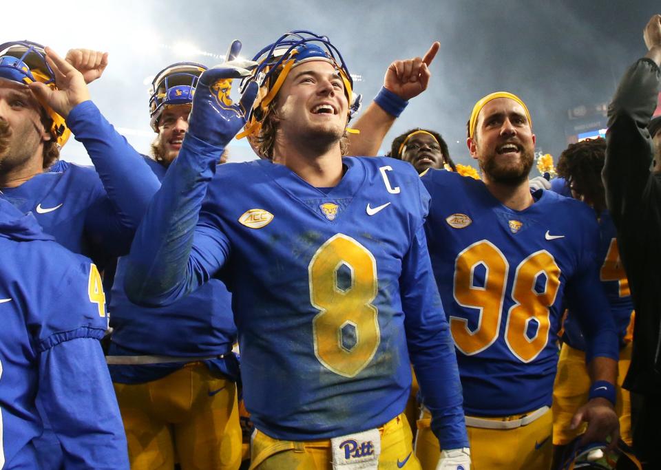 Pittsburgh Panthers quarterback Kenny Pickett (8) and Panthers punter Kirk Christodoulou (98) celebrate after defeating the Clemson Tigers at Heinz Field. Pittsburgh won 27-17.