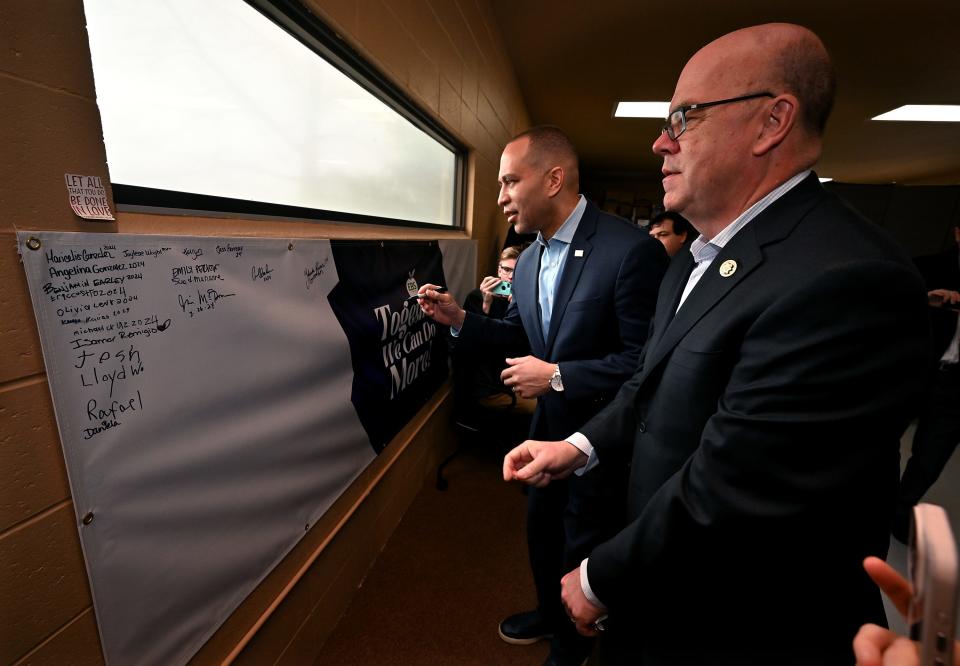 Hakeem Jeffries, House Minority Leader and Leader of the House Democratic Caucus, left, and Congressman James P. McGovern sign a visitor wall at El Buen Samaritano in Worcester in March.