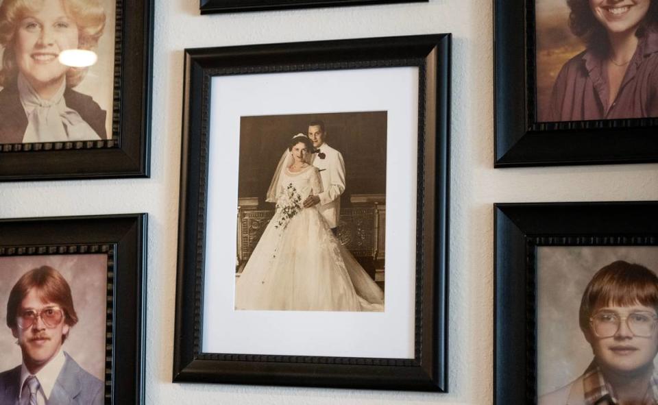 A photo of John and Jeannine Binder on their wedding day hangs alongside portraits of their six children in Jeannine’s Shawnee home. Jeannine continues to benefit from the services of a death doula even after John’s death in April.