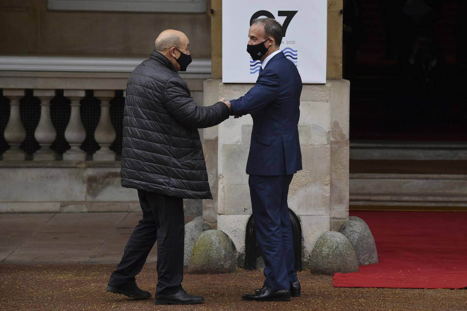 French Foreign Affairs Minister Jean-Yves Le Drian, left, is greeted by Britain's Foreign Secretary Dominic Raab at the start of the G7 foreign ministers meeting in London Tuesday May 4, 2021. G7 foreign ministers meet in London Tuesday for their first face-to-face talks in more than two years. (Ben Stansall / Pool via AP)