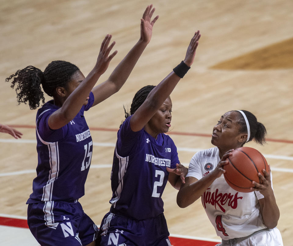 Nebraska's Sam Haiby (4) drives to the basket against Northwestern's Courtney Shaw (15) and Lauryn Satterwhite (2) in the first half of an NCAA college basketball game Thursday, Dec. 31, 2020, in Lincoln, Neb. (Francis Gardler/Lincoln Journal Star via AP)