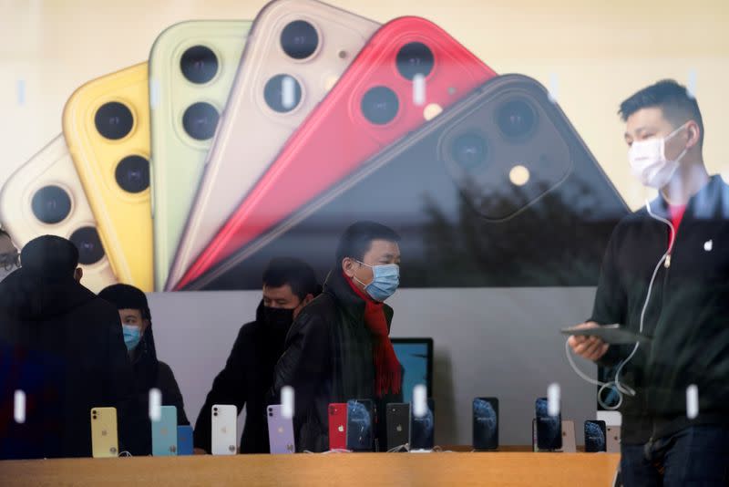 People wearing protective masks are seen in an Apple Store, as China is hit by an outbreak of the new coronavirus, in Shanghai