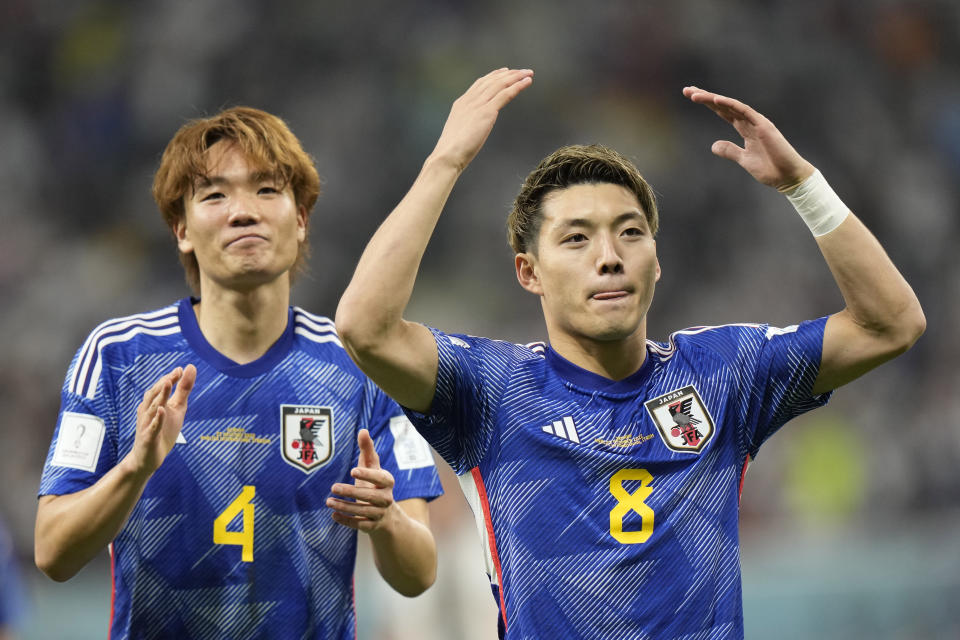 Japan's Ritsu Doan, right, celebrates after scoring his side's opening goal during the World Cup group E soccer match between Germany and Japan, at the Khalifa International Stadium in Doha, Qatar, Wednesday, Nov. 23, 2022. (AP Photo/Luca Bruno)