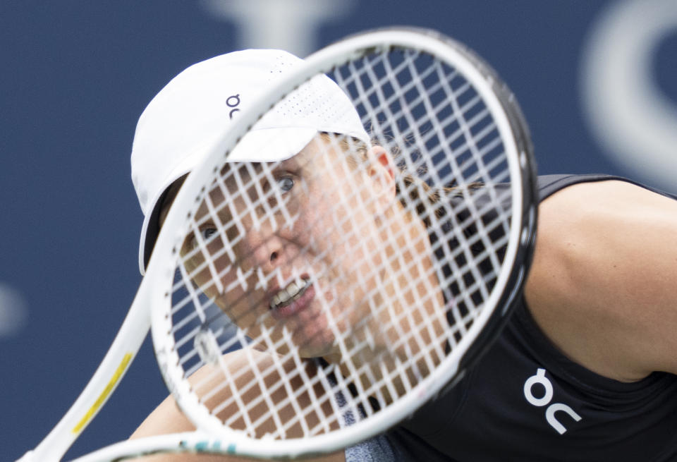 Iga Swiatek of Poland, follows through on a shot against Jessica Pegula of the United States, during the semifinals of the National Bank Open women’s tennis tournament Saturday, Aug. 12, 2023, in Montreal. (Christinne Muschi/The Canadian Press via AP)