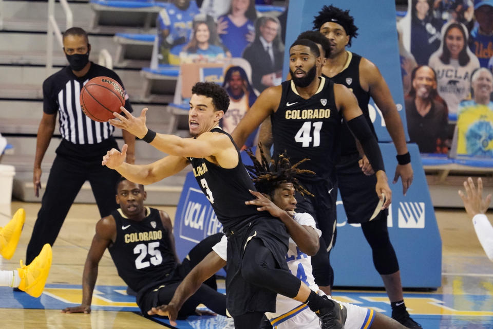 Colorado guard Maddox Daniels (3) grabs a loose ball over UCLA forward Jalen Hill during the first half of an NCAA college basketball game Saturday, Jan. 2, 2021, in Los Angeles. (AP Photo/Marcio Jose Sanchez)
