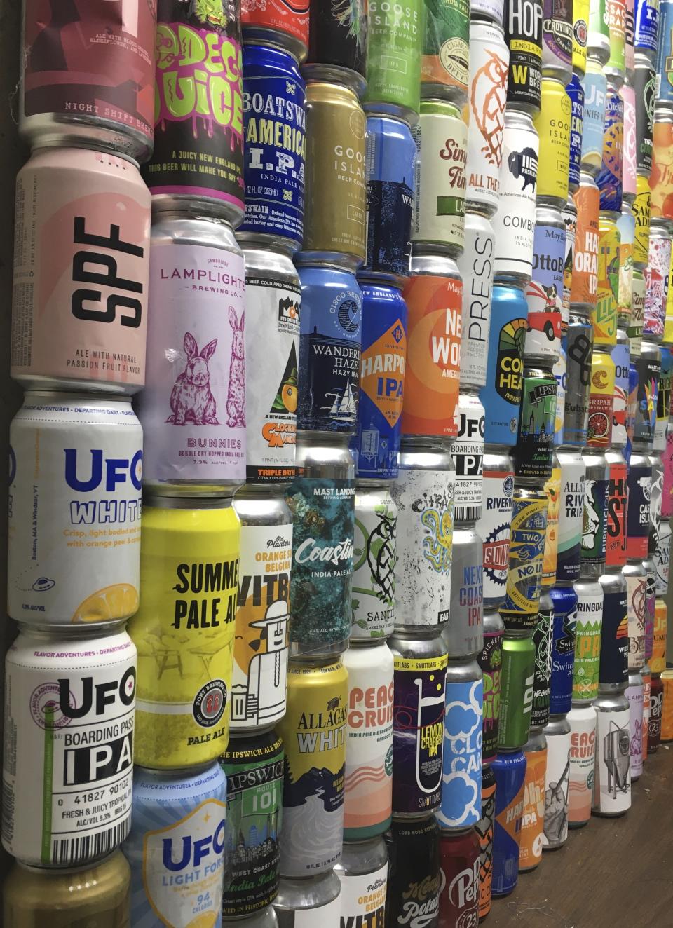 This Jan. 1, 2021 photo shows a collection of empty beer cans, consumed during the pandemic, at a home in North Andover, Mass. This year's Dry January came as many people had seen an uptick in their alcohol intake. Addiction treatment experts note that a month of forced sobriety might not have a lasting impact and could lead to binge drinking in February. But others believe the annual show of sobriety can’t hurt. (Mary Schwalm via AP)