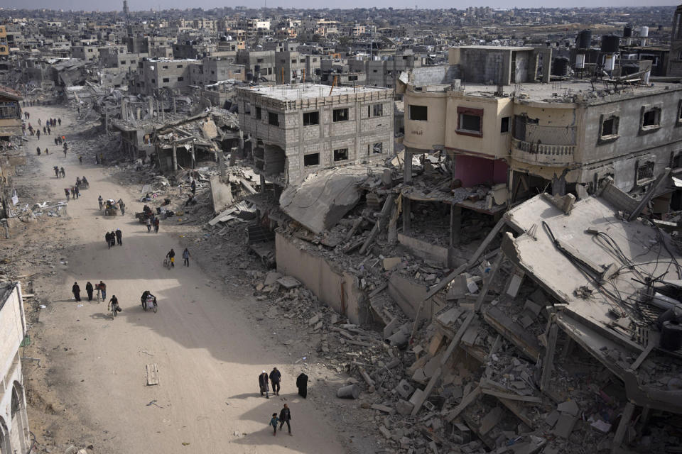 Palestinians walk through the destruction in the wake of an Israeli air and ground offensive in Khan Younis, southern Gaza, on Monday, April 8, 2024.Image: (Fatima Shbair / AP)