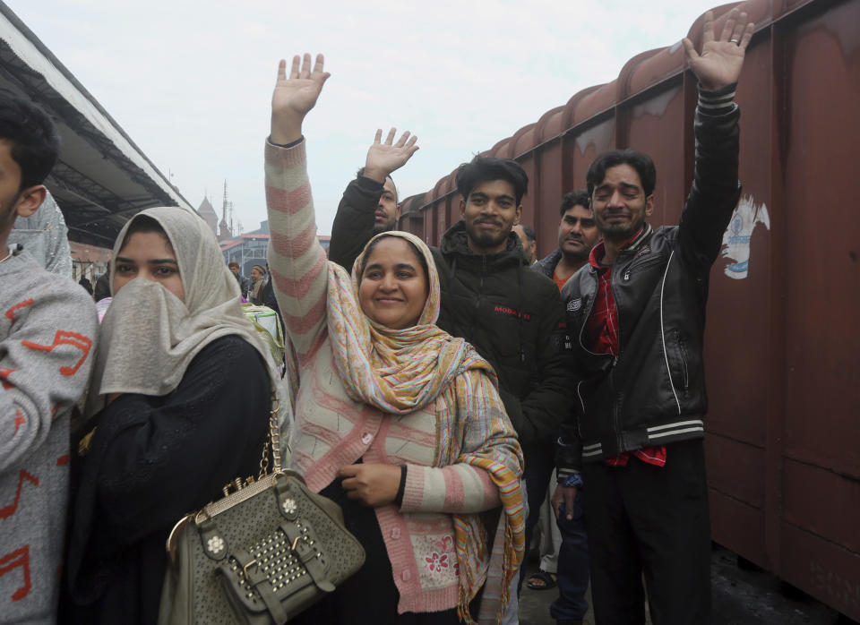 Pakistani family waves to their Indian relatives, who are leaving to return to India, after being stranded in Pakistan for a week, at Lahore Railway Station in Pakistan, Monday, March 4, 2019. A Pakistani railways official says a key train service between Pakistan and neighbouring India has been resumed, a sign on easing tensions between the two South Asian nuclear-armed rivals. (AP Photo/K.M. Chaudary)