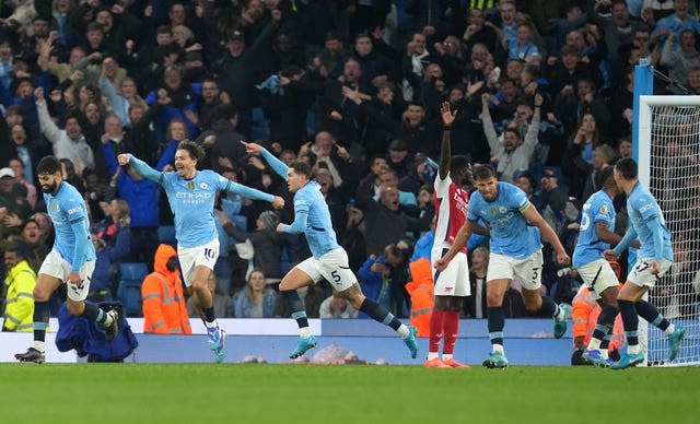 John Stones and his Manchester City team-mates run away celebrating their late equaliser 