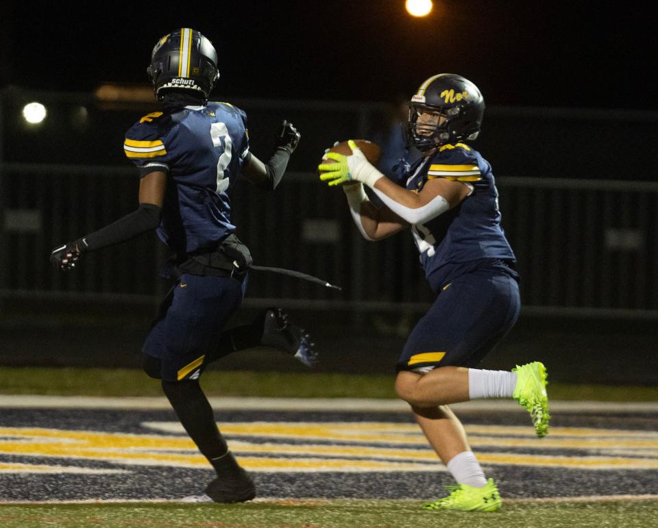 Toms River North's Tareq Council (No. 2) hands the ball to teammate Blaie Boland (No. 44) after he scored a TD on a pass in the first half of the Mariners' 49-14 win over Washington Township in the NJSIAA Central Group 5 championship game.