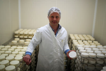 Charles Breant, one of the owners of French non-pasteurized Camembert cheese farm ''Le 5 Freres de Bermonville", holds a Camembert cheese at the farm in Bermonville, France, March 12, 2019. REUTERS/Gonzalo Fuentes