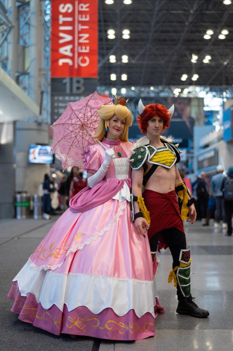 Cosplayers dressed as "Super Mario Bros." characters Princess Peach and Bowser at New York Comic Con 2022.