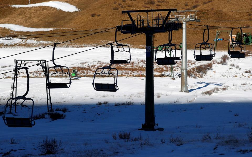 A closed chairlift is seen at the ski resort of Passo Tonale in the Dolomites which has become a virtual ghost town  - Reuters