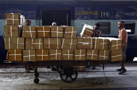 Porters prepare to load goods onto a train at a railway station in Kolkata February 25, 2015. REUTERS/Rupak De Chowdhuri