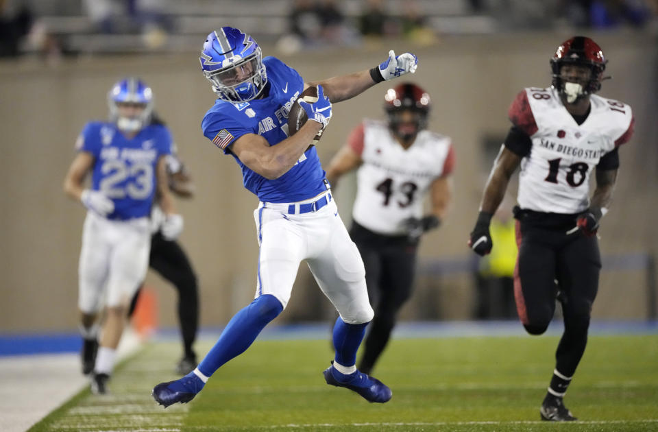 Air Force wide receiver Jake Spiewak, left, pulls in a pass as San Diego State safety Trenton Thompson pursues in the second half of an NCAA college football game Saturday, Oct. 23, 2021, at Air Force Academy, Colo. (AP Photo/David Zalubowski)