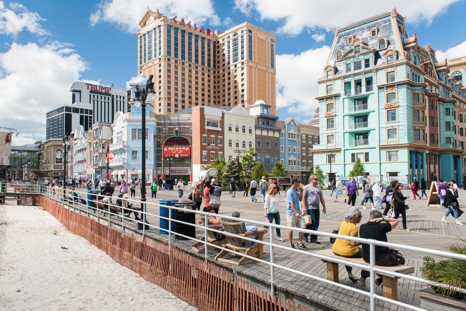 Tourists walk along the boardwalk at Atlantic City, New Jersey.