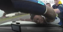 FILE - In this March 2, 2019 image from police dashboard camera video obtained by The Associated Press, Louisiana State Trooper Jacob Brown slams motorist DeShawn Washington against the hood of a police cruiser during a traffic stop in Ouachita Parish, La., after troopers found marijuana in the trunk of Washington's car. (Louisiana State Police via AP)