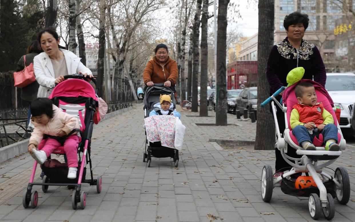 People push baby carriages outside the Ritan Park in Beijing, China - WU HONG /EPA
