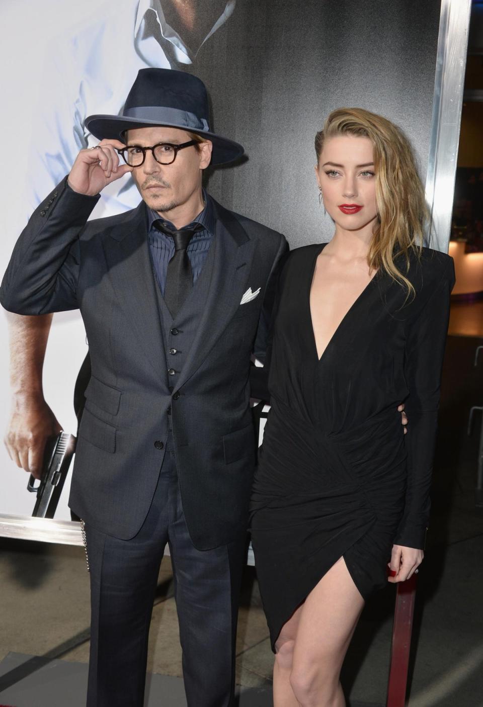 February 12, 2014 <br><br>ohnny Depp and Amber Heard pose for a photo at the premiere of <i>3 Days To Kill</i> in Los Angeles, CA, USA (Getty Images)