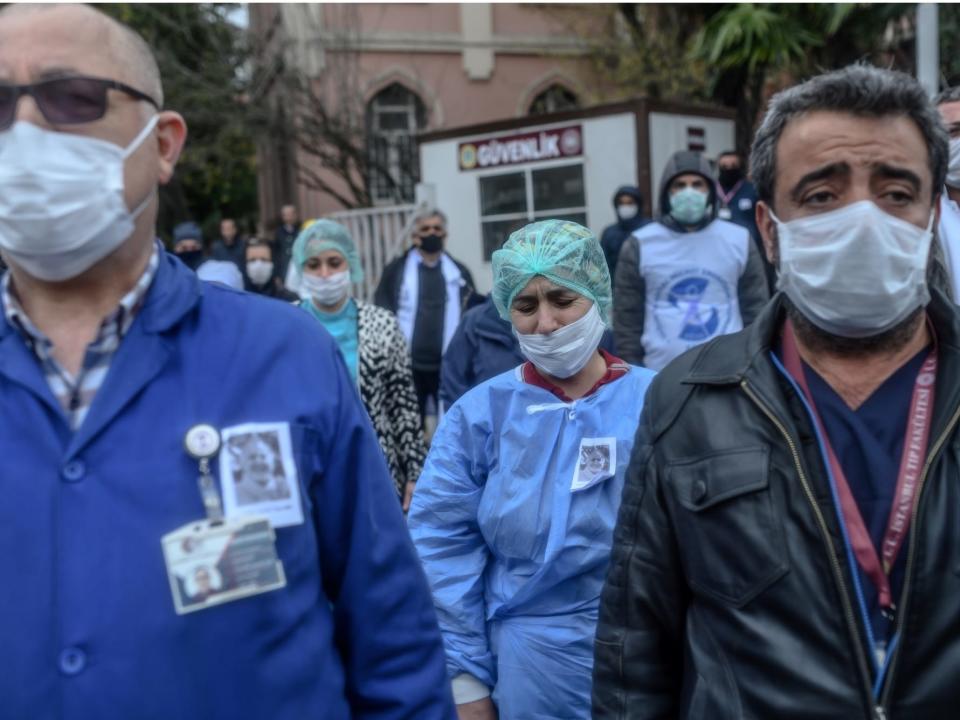 Health workers mourn outside Istanbul University Faculty of Medicine during a commemoration for professor Cemil Tascooglu, the country's first medical professional to pass away from COVID-19, on April 2.