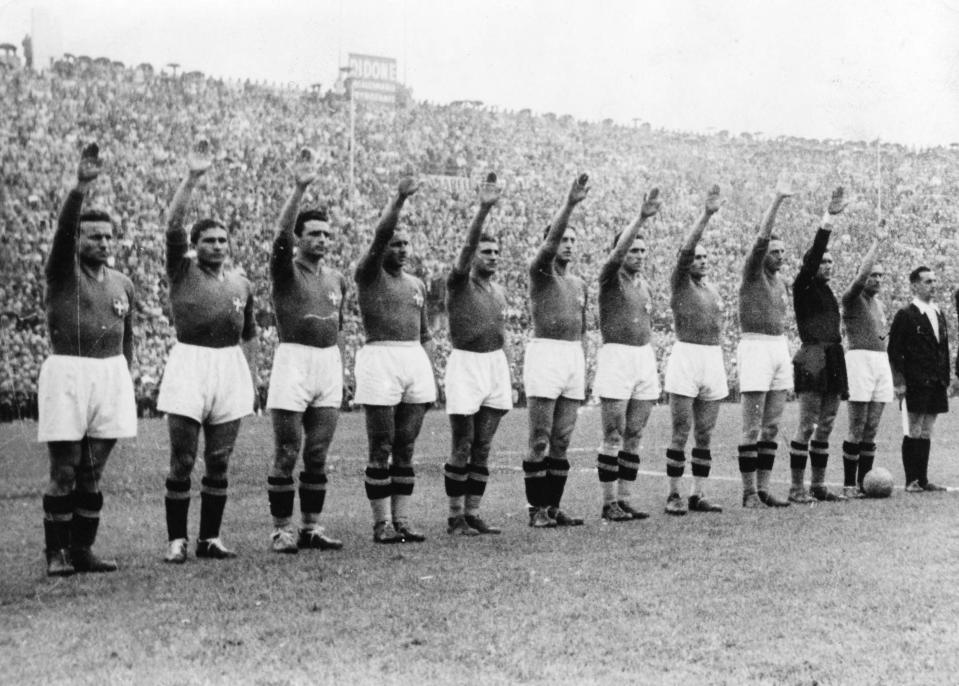 FILE - The Italian soccer team perform the fascist salute in Colombes Stadium, Paris, before the start of the World Cup final soccer match against Hungary on June 19, 1938. Earlier in the tournament that was taking place amid the drumbeat of war, the team caused consternation by wearing black shirts in a match. (AP Photo/File)