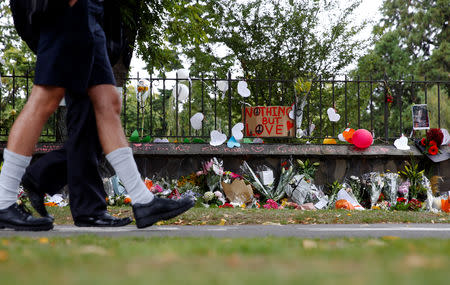 Flowers and signs are seen at a memorial site for victims of the mosque shootings, at the Botanic Gardens in Christchurch, New Zealand, March 18, 2019. REUTERS/Edgar Su