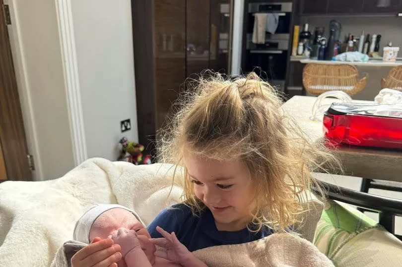 Joe Wicks son Marley holding his new sibling