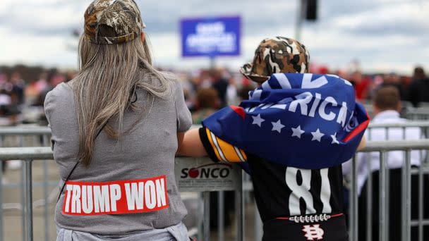 PHOTO: People stand ahead of a pre-election rally held by former U.S. President Donald Trump in support of Republican candidates in Latrobe, Pa., Nov. 5, 2022.  (Mike Segar/Reuters)