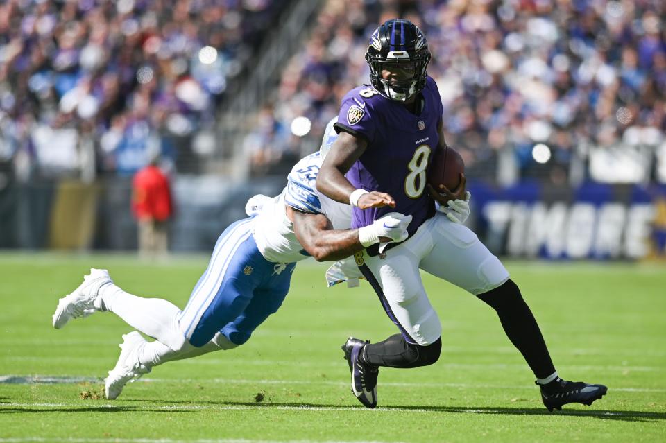 Baltimore Ravens quarterback Lamar Jackson runs in the first half for a first down against the Detroit Lions at M&T Bank Stadium in Baltimore on Sunday, Oct. 22, 2023.