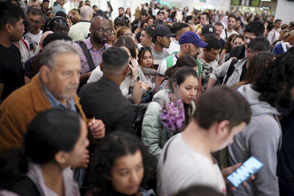 Passengers crowding at the entrance to the platforms at Sants train station in Barcelona, Sunday, May 12, 2024. Catalonia's commuter rail service said it was forced to shut down several train lines due to the robbery of copper cables from an installation near Barcelona. Potentially thousands of voters had trouble reaching their polling stations after Catalonia's commuter rail service had to shut down several train lines due to what officials said was the robbery of copper cables from an installation near Barcelona. (AP Photo/Joan Mateu Parra)