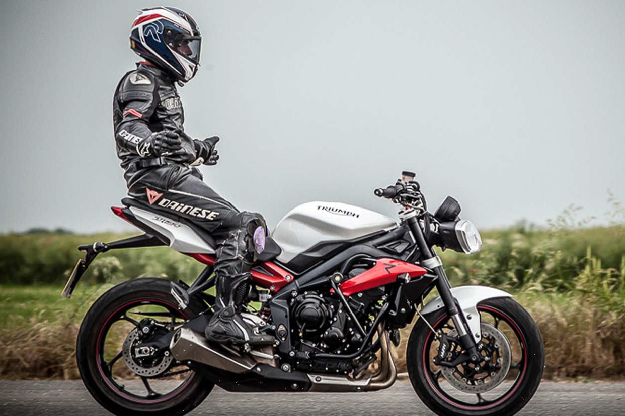 Look, no hands: i2i instructor Tom Killeen demonstrates the surprising stability of a motorbike to his pupils