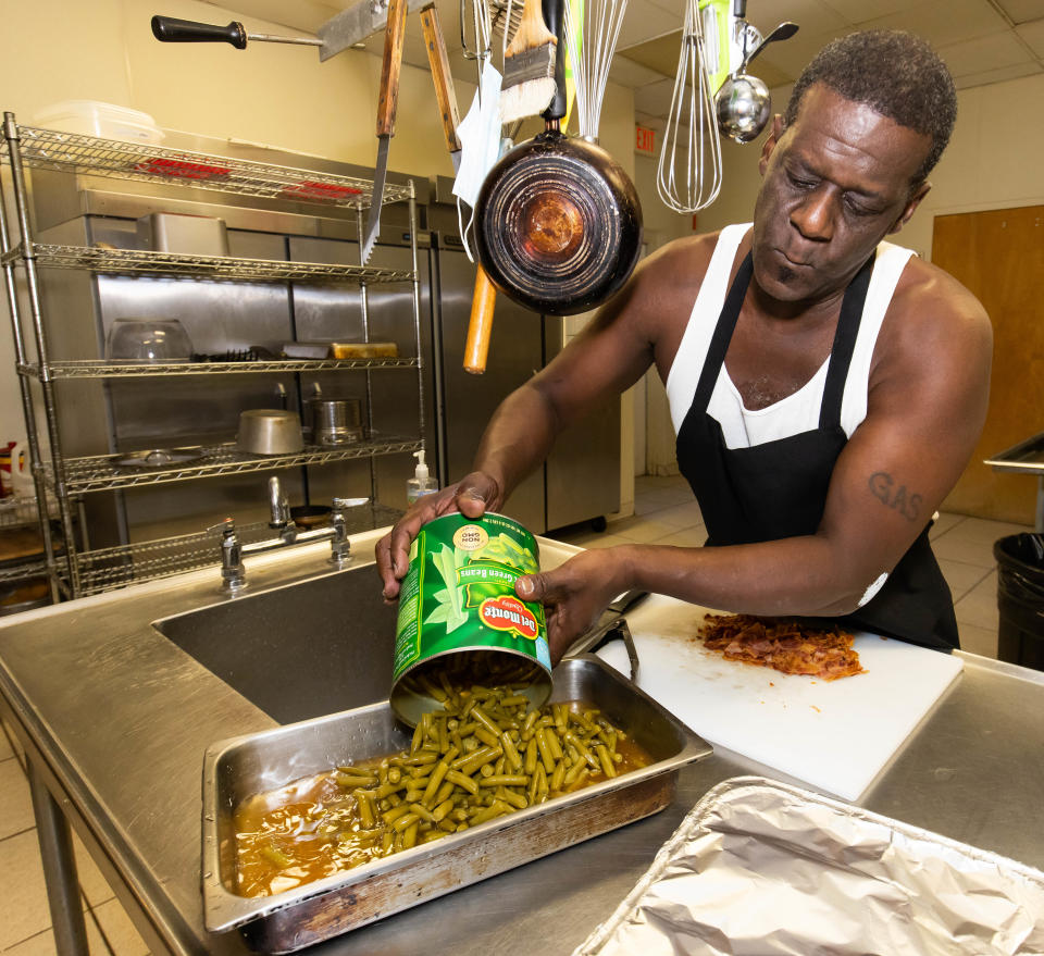 Robert Gadson, a resident at Open Arms Village for only about a month, makes dinner for the 19 residents last week. "It's a good spot to be in. It's a vast amount of things that this place helps by refurbishing your life," Gadson said.