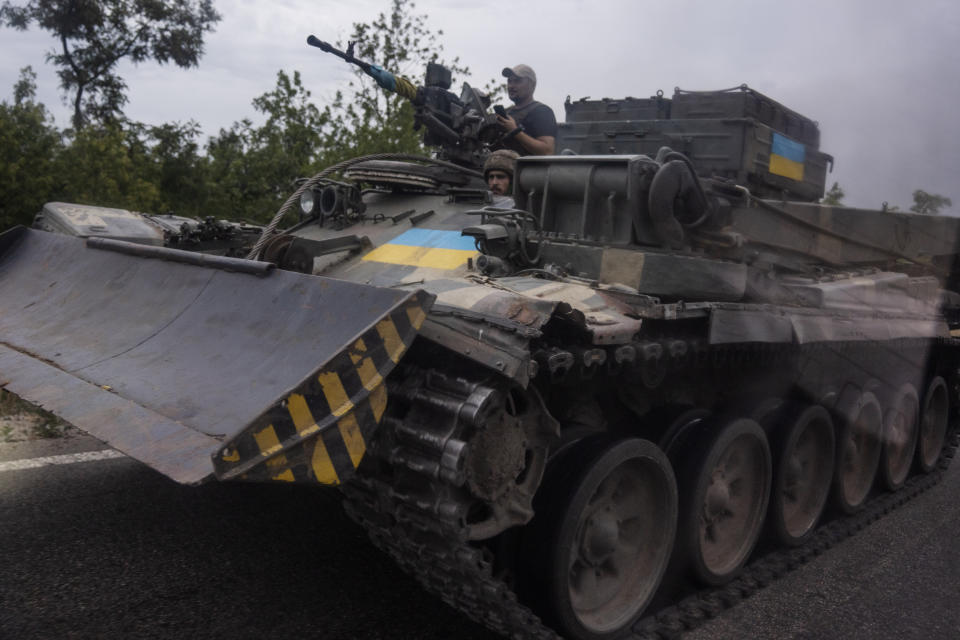 FILE - Ukrainian soldiers ride a tank on a road, in Stupochky, Donetsk region, eastern Ukraine, Sunday, July 10, 2022. Ukrainians living in the path of Russia's invasion in the besieged eastern Donetsk region are bracing themselves for the possibility that they will have to evacuate. (AP Photo/Nariman El-Mofty, File)
