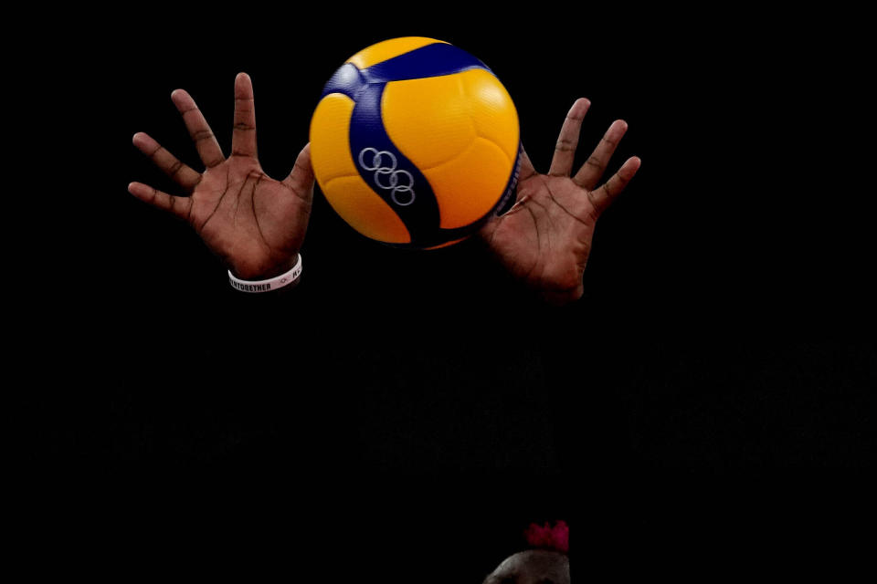 The hands of Kenya's Sharon Chepchumba Kiprono block the ball during the women's volleyball preliminary round pool A match between Dominican Republic and Kenya at the 2020 Summer Olympics, Saturday, July 31, 2021, in Tokyo, Japan. (AP Photo/Frank Augstein)