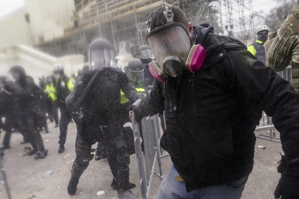 Trump supporters try to break through a police barrier, Wednesday, Jan. 6, 2021, at the Capitol in Washington. As Congress prepares to affirm President-elect Joe Biden's victory, thousands of people have gathered to show their support for President Donald Trump and his claims of election fraud. (AP Photo/John Minchillo)