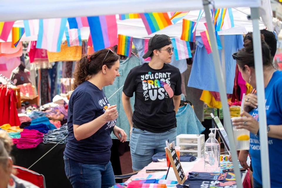 Cara Ellis, left, and Sarah Ratliff talk to festival goers at Pikeville Pride’s booth at the Hillbilly Days Festival in Pikeville, Ky., on Thursday, April 20, 2023.