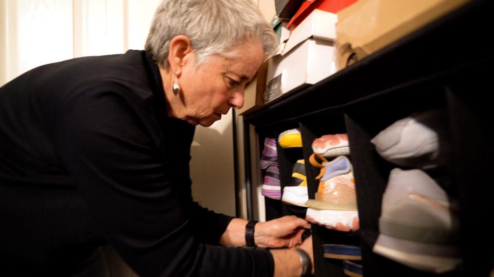 Ellen Gurwitz of De-Clutter Me! VT organizes a shoe rack in Essex Junction on March 29, 2023.