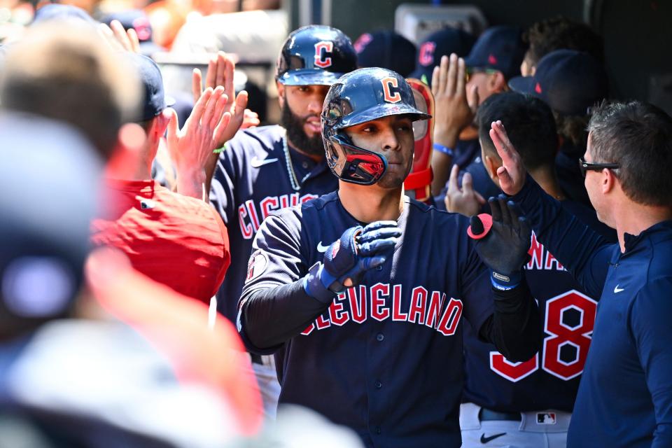 Cleveland Guardians' Andres Gimenez is greeted by teammates after hitting a three-run home run against Baltimore Orioles starting pitcher Dean Kremer during the first inning of a baseball game, Sunday, June 5, 2022, in Baltimore. (AP Photo/Terrance Williams)