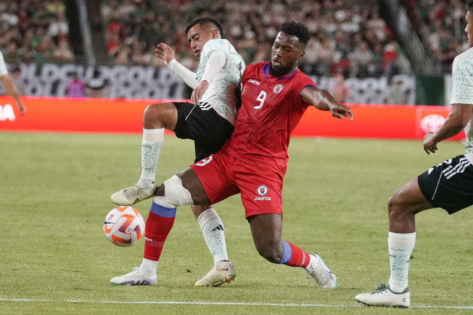 Mexico's Erick Sanchez, left, vies for the ball against Haiti's Duckens Nazon during the first half of a CONCACAF Gold Cup soccer match Thursday, June 29, 2023, in Glendale, Ariz. (AP Photo/Darryl Webb)