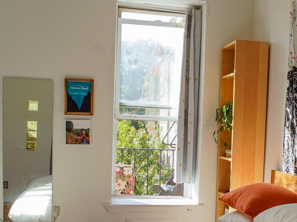 The author's fire escape is seen out the window past her bed and bookshelf.