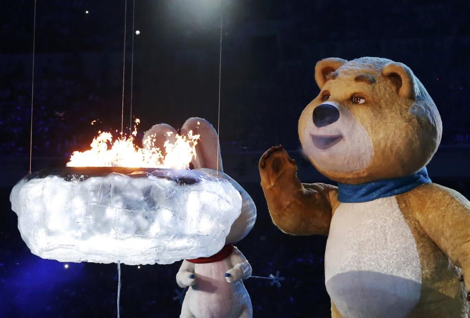 The Olympic Games mascots extinguish the Olympic flame in a small cauldron in the stadium during the closing ceremony for the Sochi 2014 Winter Olympics, February 23, 2014. REUTERS/Lucy Nicholson (RUSSIA - Tags: SPORT OLYMPICS)