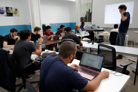 Students work in their web development class as part of professional training at the Simplon.co school specialized in digital sector in Montreuil, near Paris, France, June 14, 2018. Picture taken June 14, 2018. REUTERS/Philippe Wojazer