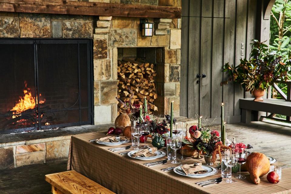 <p>"We love mixing in natural elements with the candles, dinnerware, and the shapes of the dried gourds and squashes are the perfect touch," says Mary Celeste Beall, proprietor of <a href="https://www.blackberryfarm.com/" rel="nofollow noopener" target="_blank" data-ylk="slk:Blackberry Farm;elm:context_link;itc:0;sec:content-canvas" class="link ">Blackberry Farm</a>. "The tablecloth and napkins set a classic but inviting foundation for a fall table."</p><p>This festive scene feels straight from a magazine yet is casual enough to make all your loved ones feel cozy and comfortable at the table. The meal is just the cherry on top!</p>